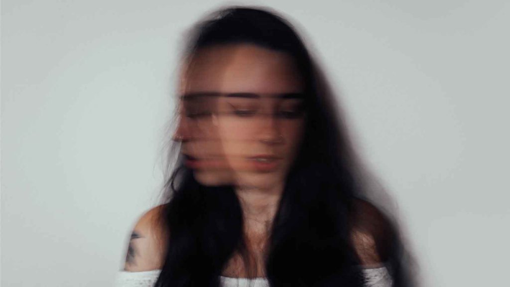 A blurry picture of a woman with long brown hair illustrates how anxiety and depression can make you feel out of focus.