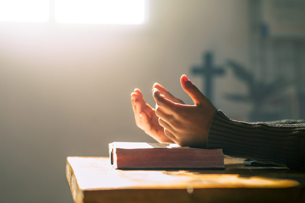 Open hands on an open bible in a sunny room where you ask the question, "Did Jesus meditate?"