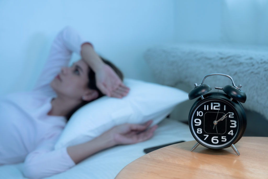 A woman lies awake in bed at 2 a.m. wondering if biblical meditation can help you sleep