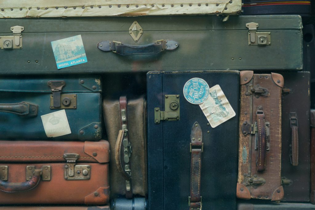 A stack of old suitcases with travel stickers on them might make it hard staying calm when you travel.