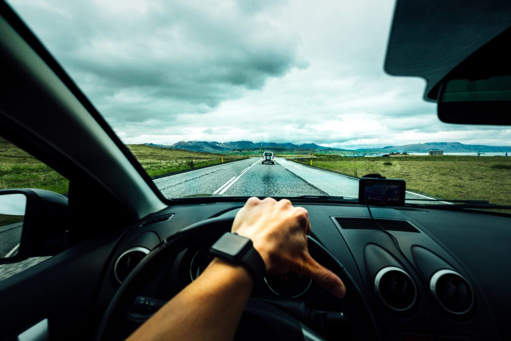 A driver on the road proceeds carefully as he prays a prayer for safe travels.