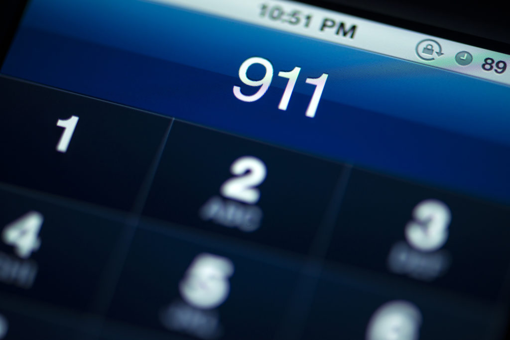 The numbers 911 on a smartphone remind us to pray a morning prayer for first responders.
