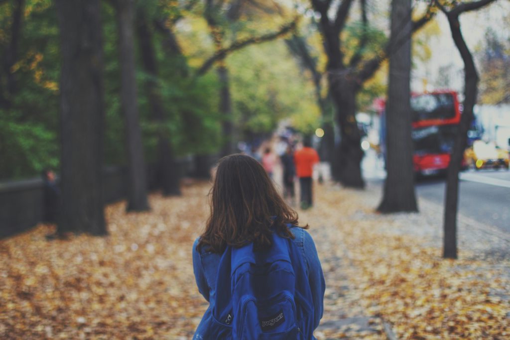 a young girl walks alone knowing that being understood would help her mental health.