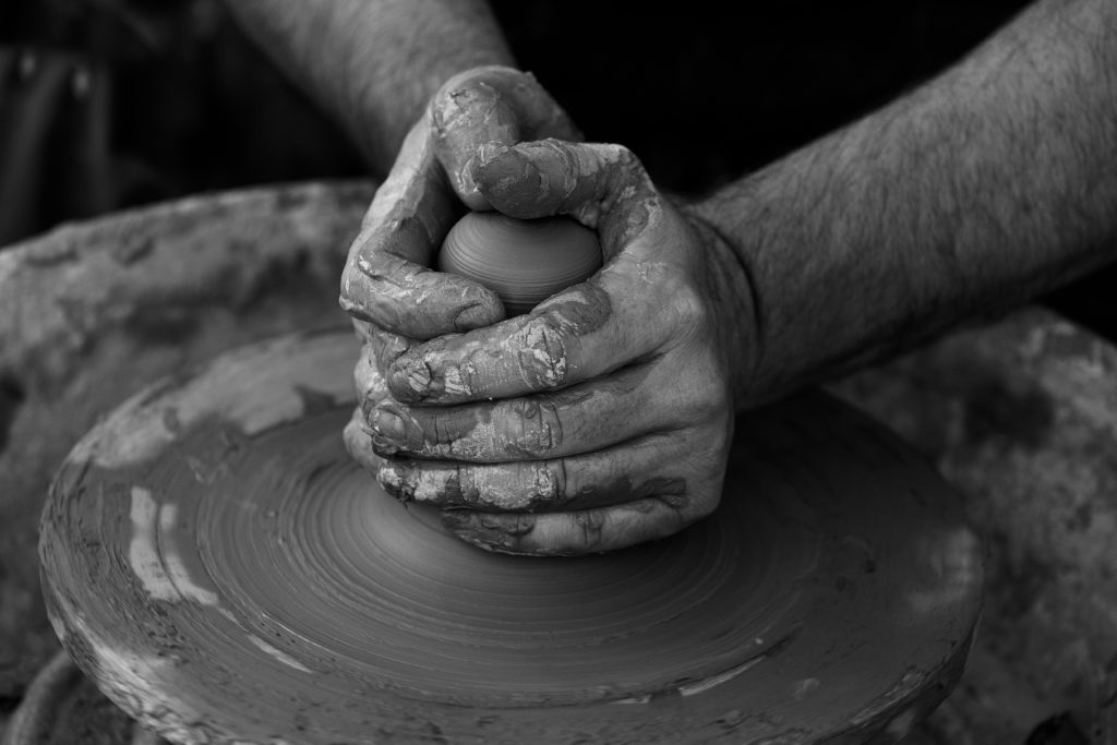 A potter's hands shaping clay remind us that God is always working and we can be finding joy in His work.