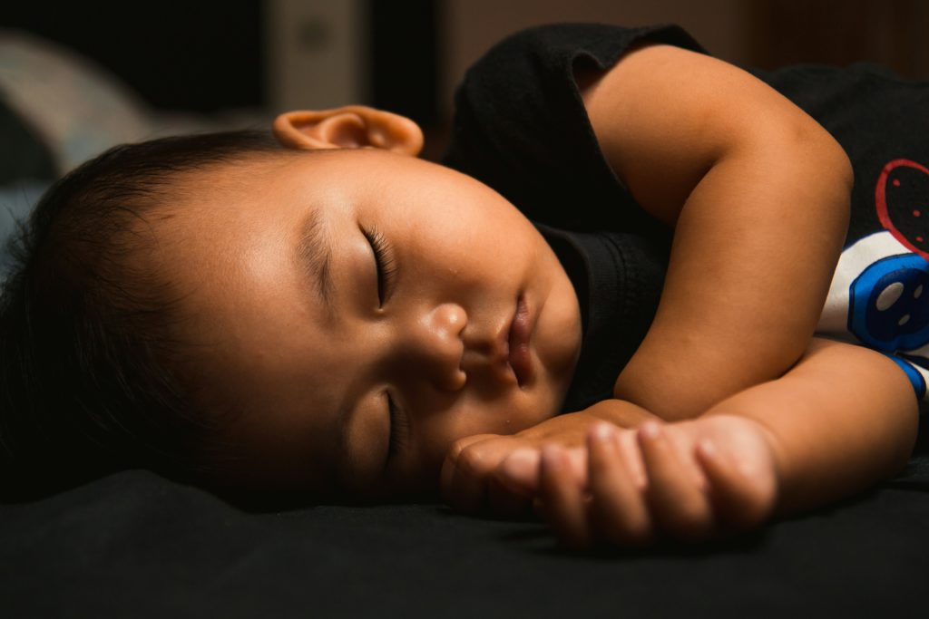 A young child sleeps peacefully after his parents incorporate a Bible-based bedtime routine.