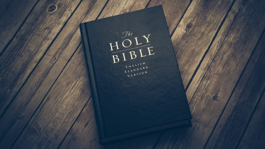 Royalty-free stock photo: A Bible rests on a wooden table
