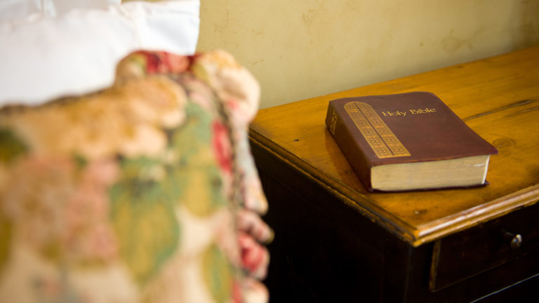 Royalty-free stock photo: a Bible rests on a bedside table Scripture for Better Sleep