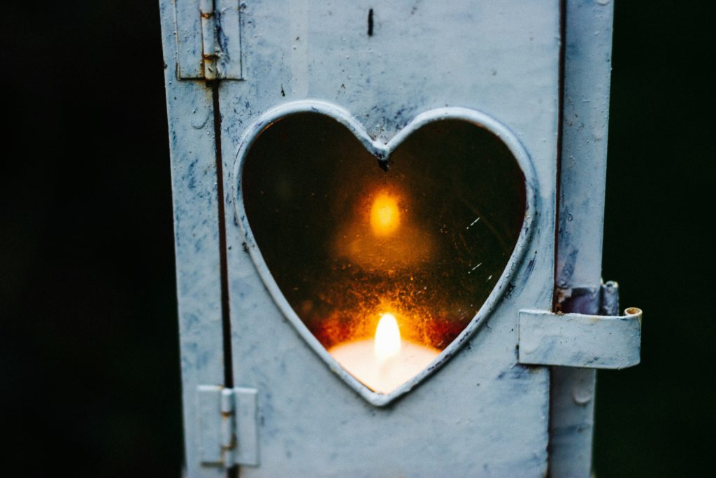A candle shining inside a heart-shaped opening show us that God is present when fear and paranoia steal our sleep.