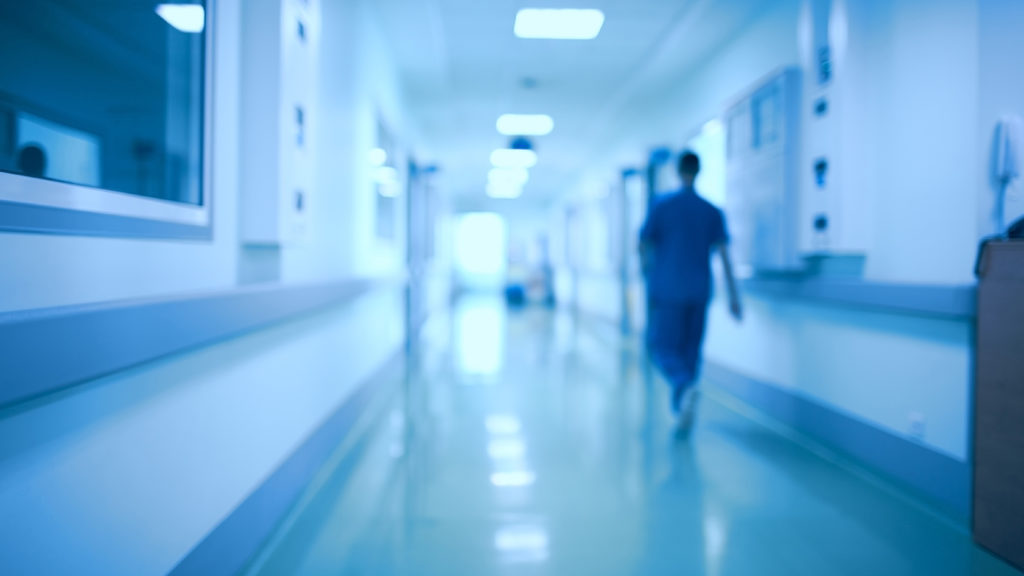 Royalty-free stock photo: A hospital corridor where a mom finds peace in prayer