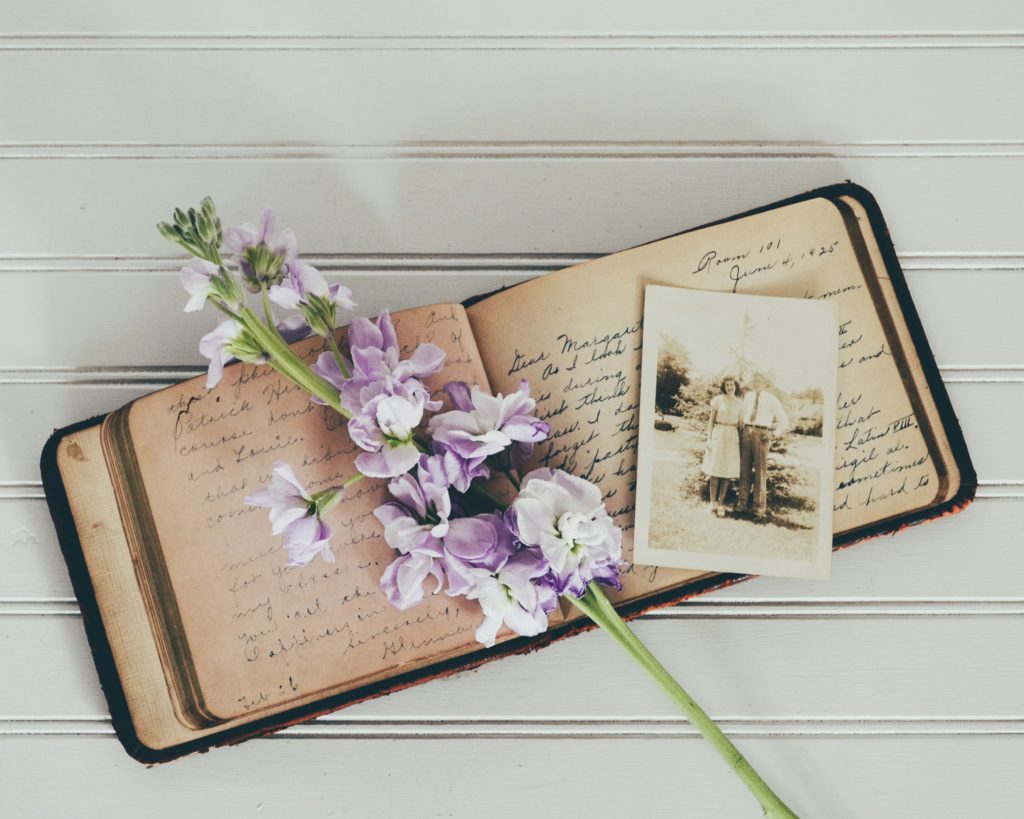 Purple flowers, an old journal, and an old picture remind us of the benefits  of meditating on God's Word to remember what He's done in the past.