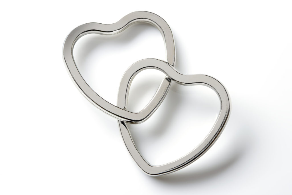 Two entwined silver hearts represent God's love that is a part of the nighttime promises of connection.