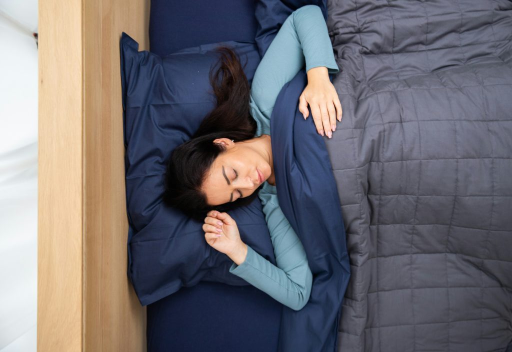 A woman get a restful night of sleep in her bed.