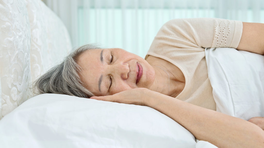 Royalty-free stock photo: A woman enjoys a restful sleep thanks to Christian meditation and Bible study