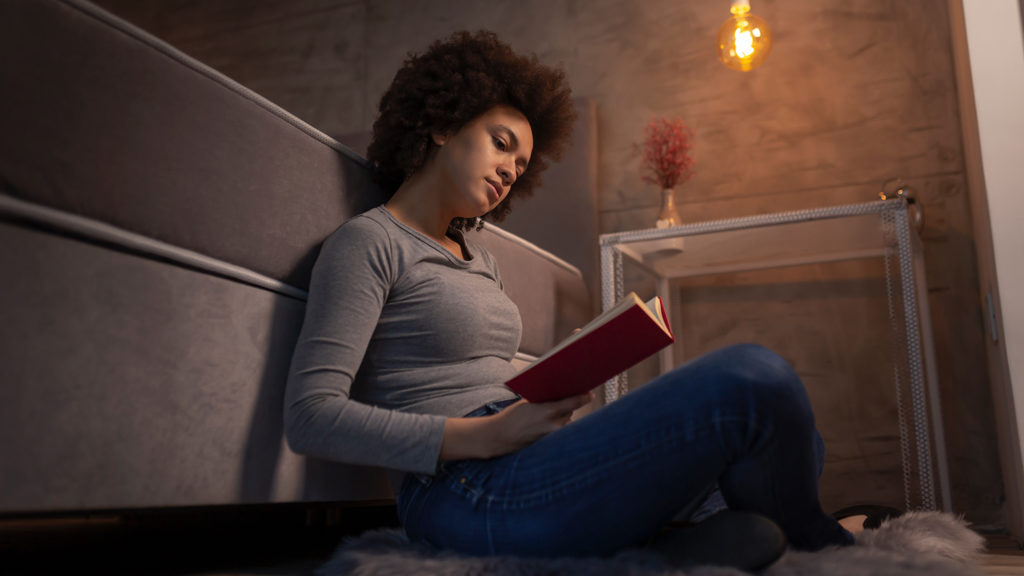 Royalty-free stock photo: A woman reads the Bible at bedtime