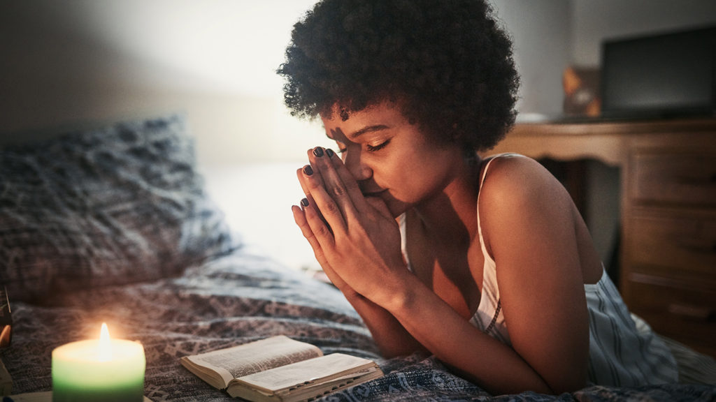 Royalty Free Stock Photo: Woman saying evening prayers at bedtime