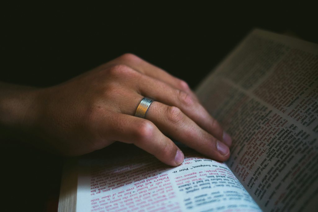 A hand on an open Bible helps you to know that spending time in God's Word helps you do what is right.