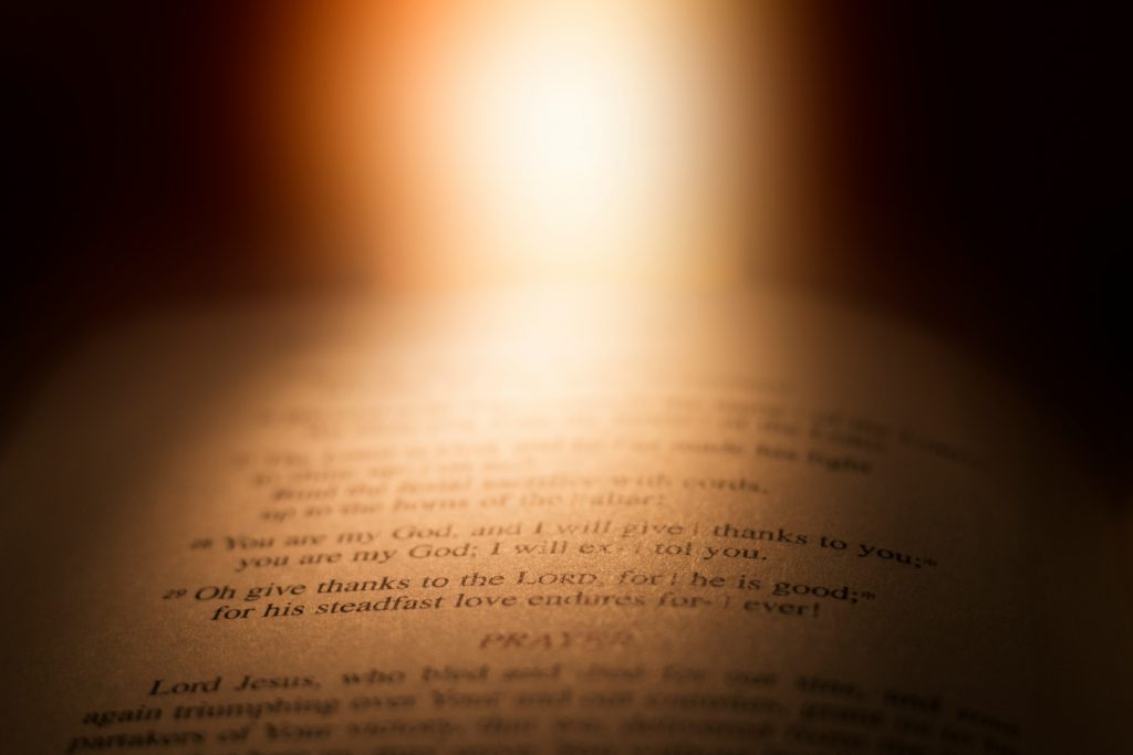 A bright light shining on the pages of an open Bible can help you move from confusion to clarity.
