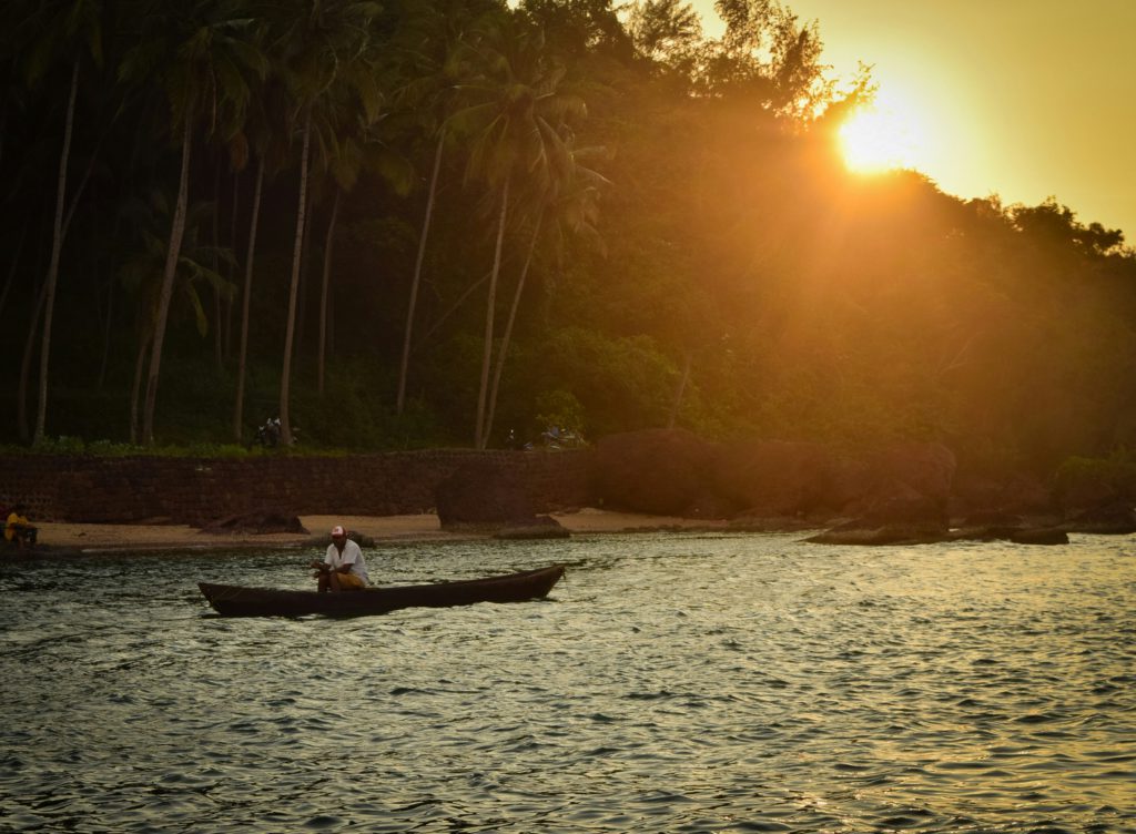 A fisherman in a row boat at sunset shows the patience needed to overcome offenses with compassion.
