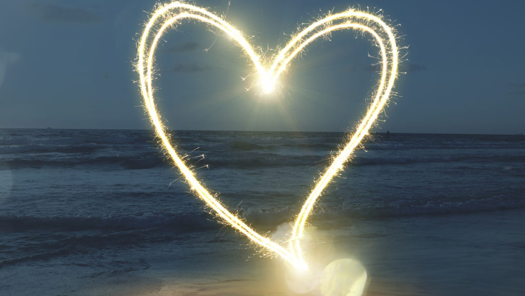 A glowing light heart over the ocean reminds us to keep a tender heart.