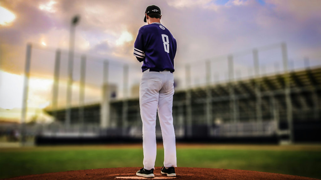 A baseball pitcher stands on a mound ready to be a game changer.