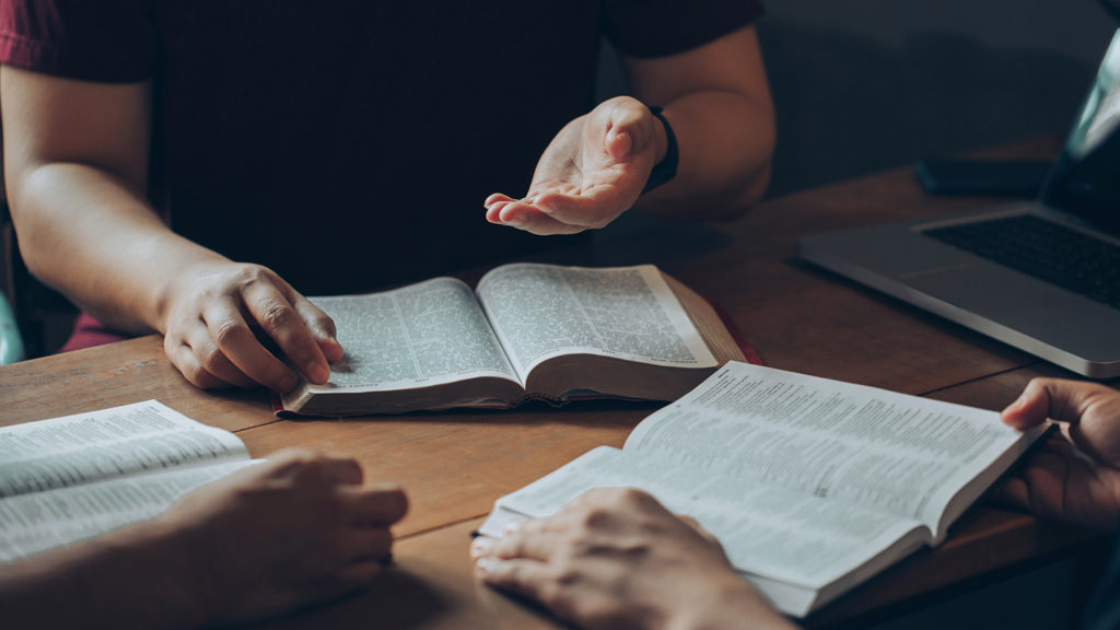Royalty-Free Stock Photo: Group reading the Bible and Scripture's lightbulb moments together.