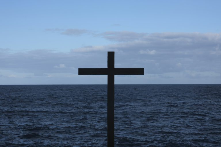 A lone wooden cross set in front of the ocean reminds us of our divine worth.