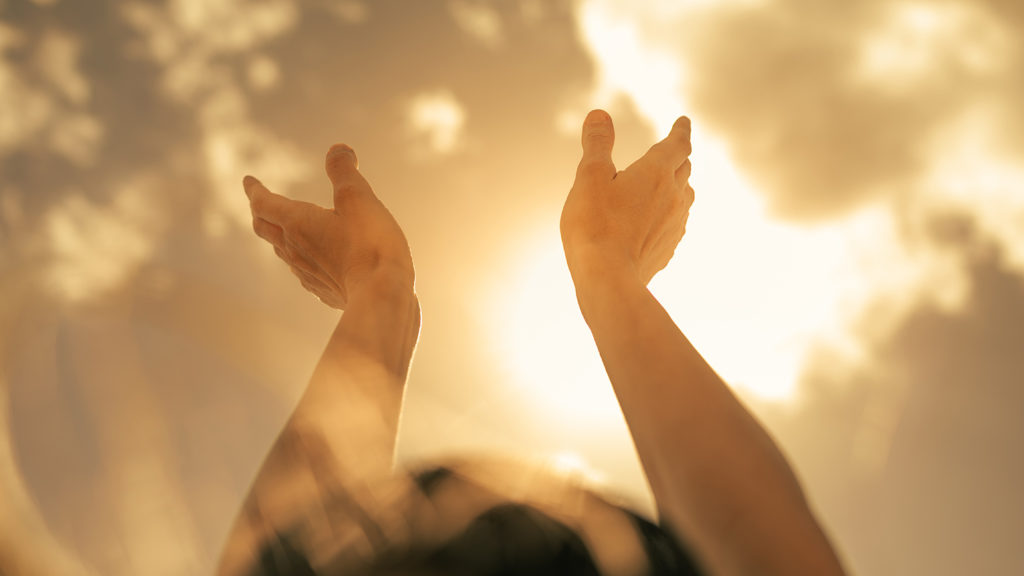 Royalty-Free Stock Photo: Hands reaching up towards the sun and facing doubt.
