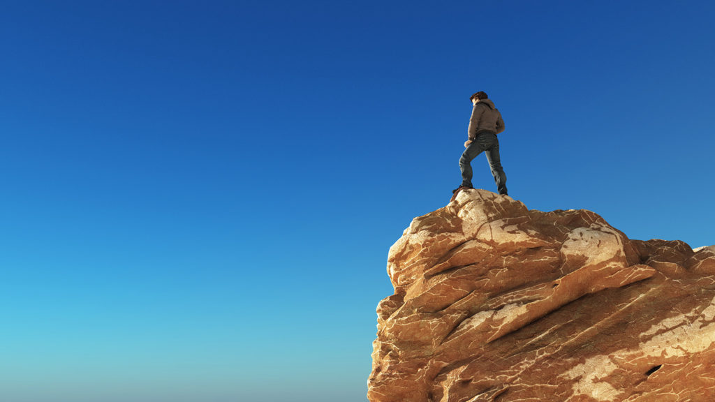 Royalty-free stock image: A man looks out from the edge of a cliff. Getty Images