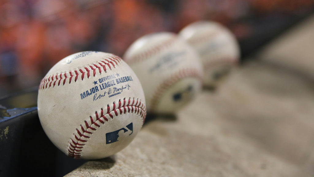 Three baseballs lines up on a concrete edge symbolize 3 of life's biggest questions.