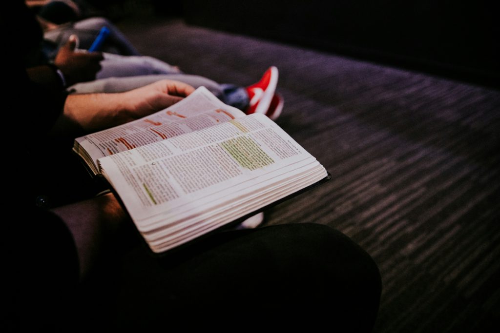 A man sits with an open Bible with many highlighted passages knowing that you can reclaim your confidence with God's Word.