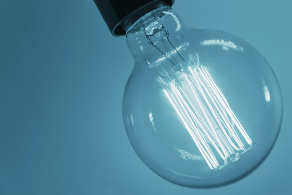 A clear, round Edison lightbulb glows with unexpected insights.