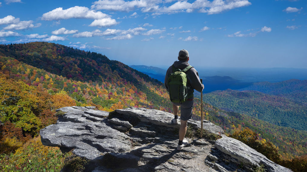 A man stands on a rocky outcropping looking out over the Blue Ridge Mountains where he answers the question, "What is contentment?"