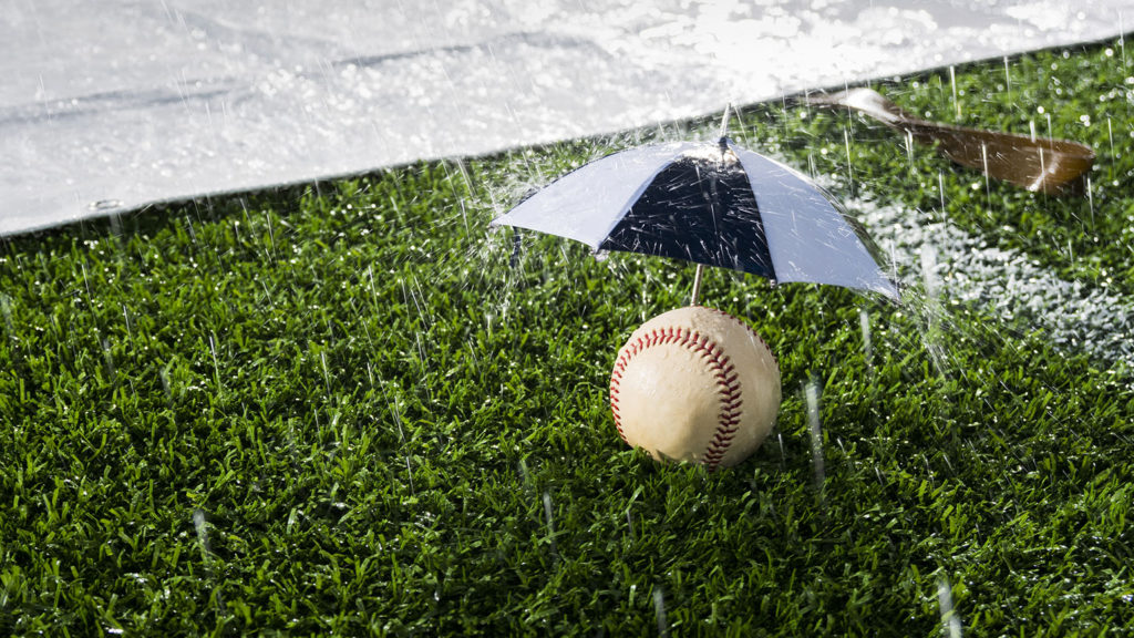 A Baseball sitting under an umbrella during a Rain Delay calls for us all not to be fair-weather fans.