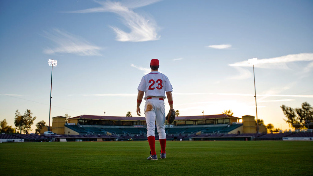 Royalty-Free Stock Photo: Baseball player on the field finding common ground between faith and baseball,