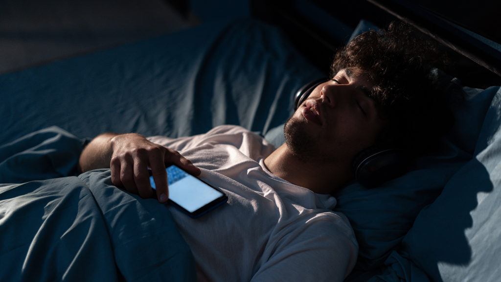 Man listens to Christians meditations in bed to help with insomnia