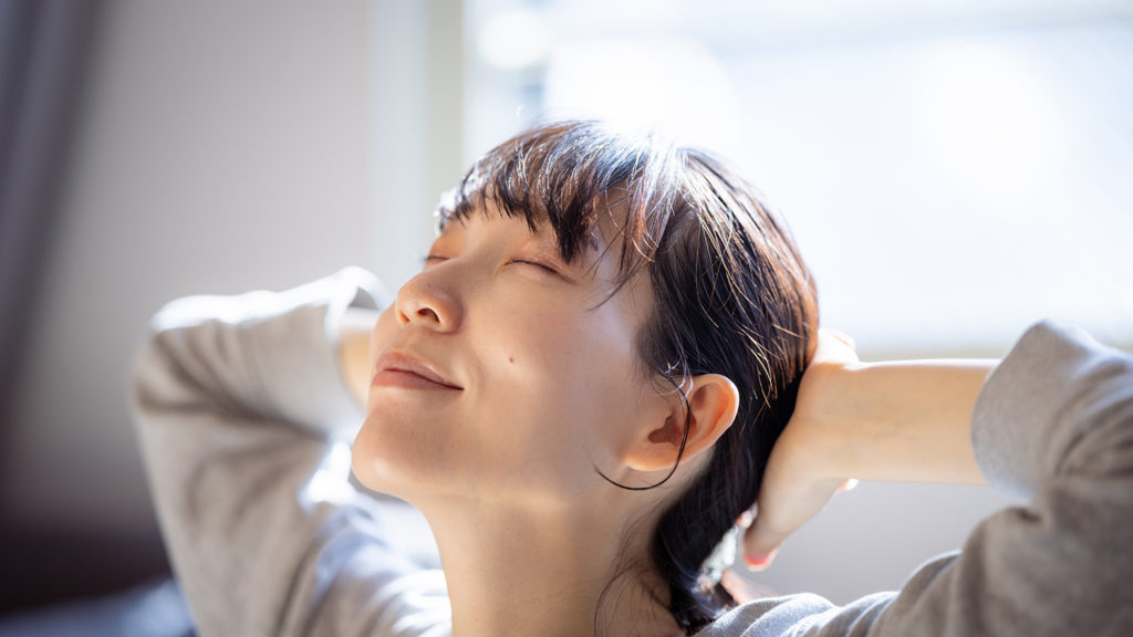 Woman with her eyes closed learning how to turn off her mind