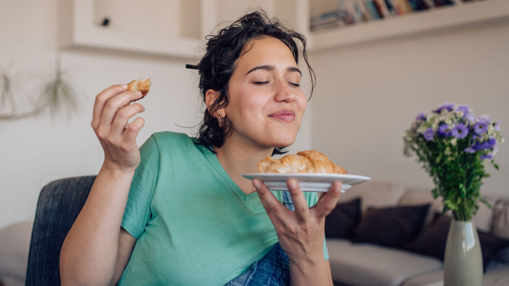 A young woman savors the taste of delicious food as she learns about experiencing God through her senses.