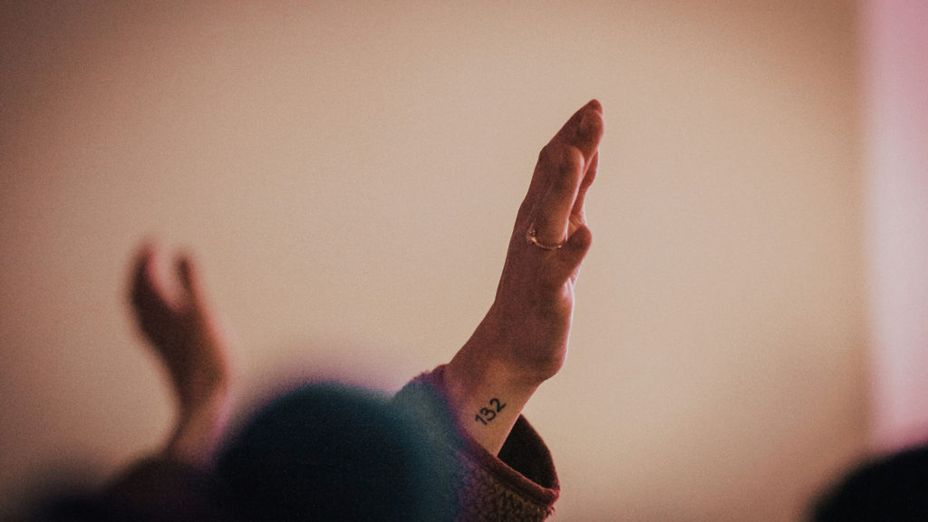 Hands raised in worship remind us to praise God when faith and anxiety battle. 