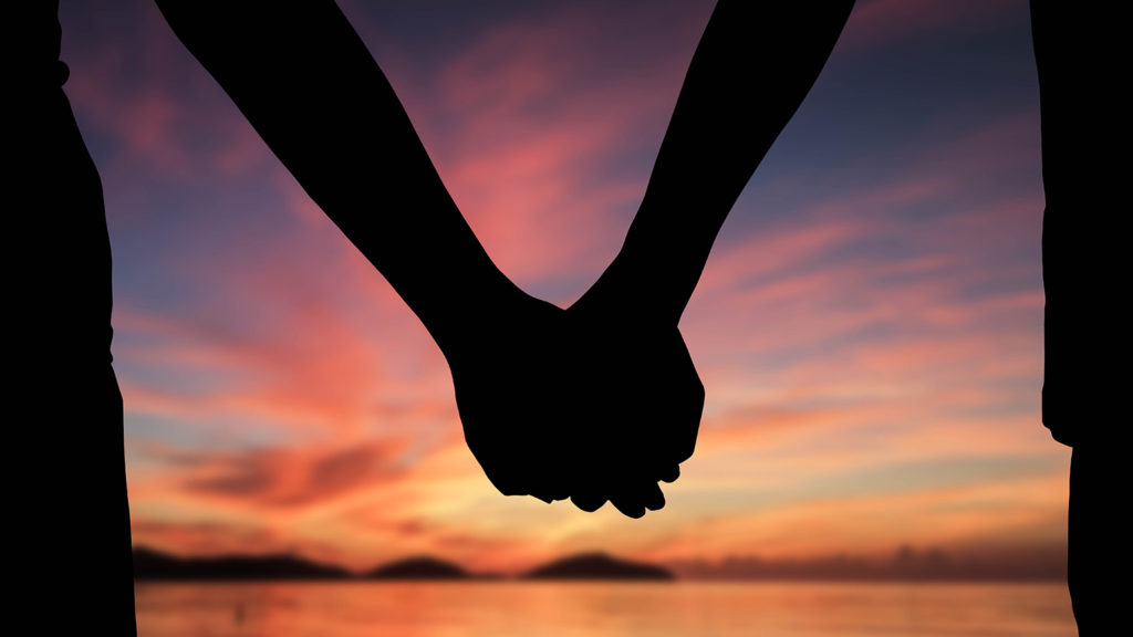 Royalty-Free Stock Photo: Silhouette of a couple holding hands before doing a nighttime prayer.