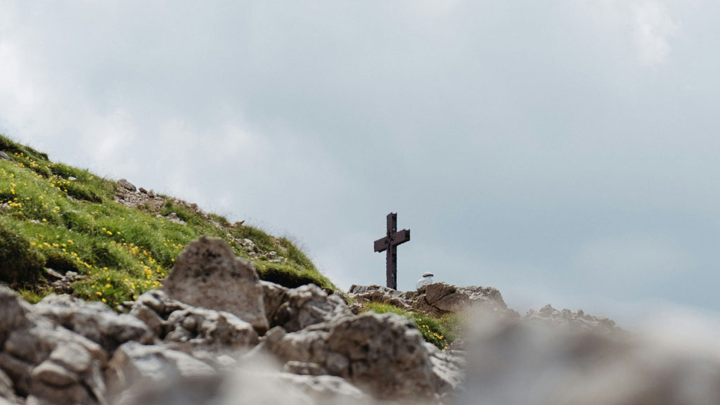 A cross stands on a hill showing us the power of influence.