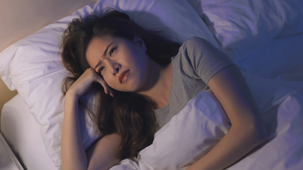 Royalty-free stock images: A woman struggles to get to sleep; Getty Images