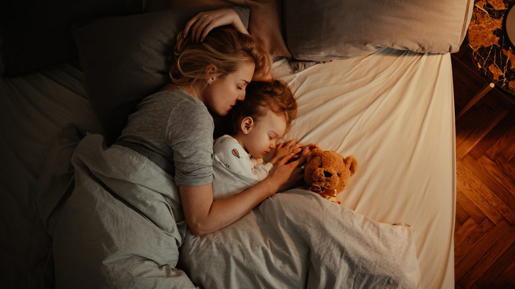 Royalty-Free Stock Photo: Mother and daughter sleeping together after listening to a sleep meditation.