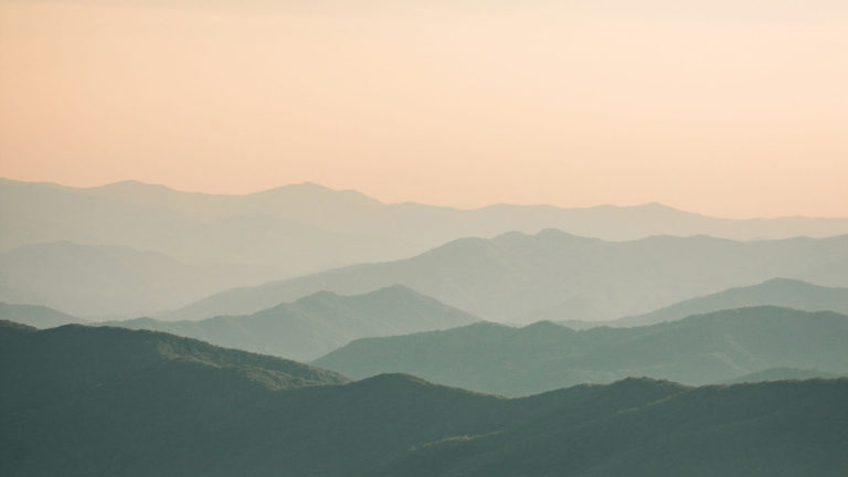 Blue-tinged mountains at sunset remind us that we are surrounded by rest.